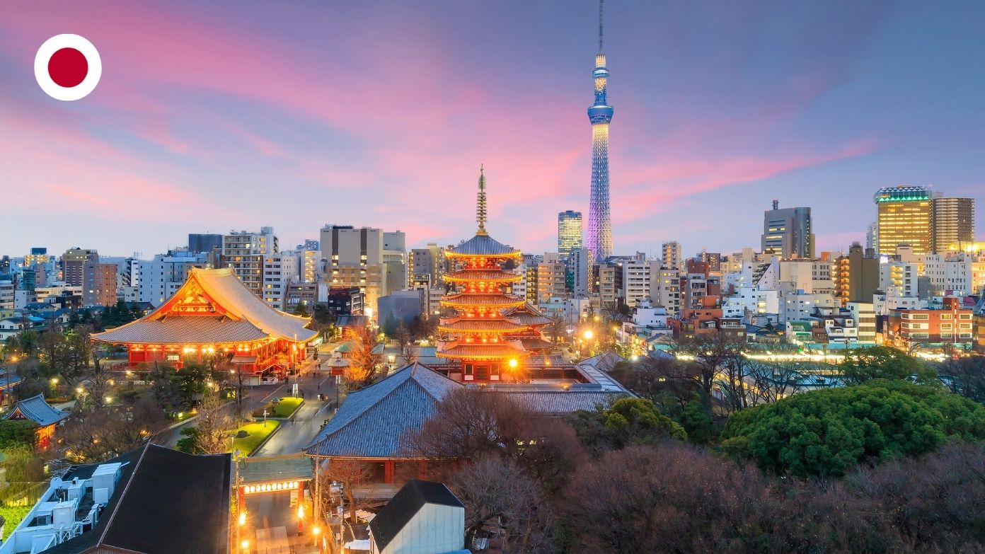 Tokyo Skytree and illuminated Senso-ji Temple at sunset, with a circular Japanese flag icon in the corner.