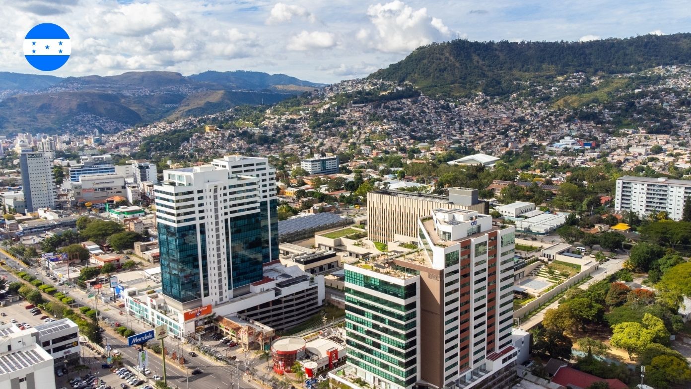 Aerial view of modern skyscrapers in Tegucigalpa, Honduras, with residential hills in the background​​ 