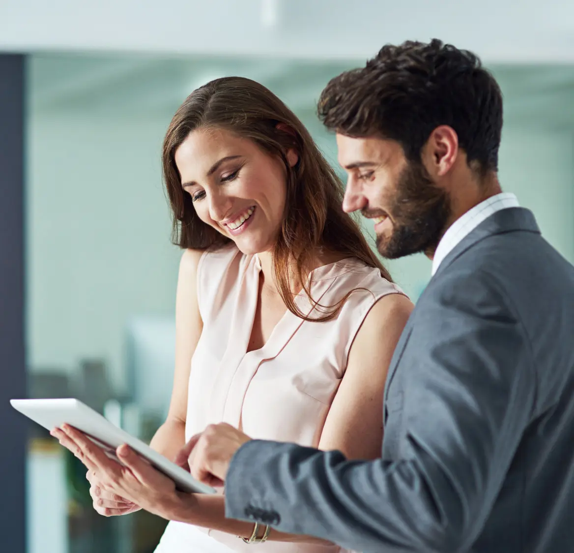 Two people looking at a tablet